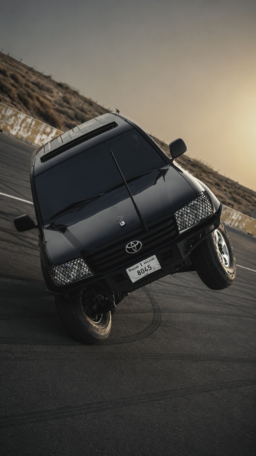 Toyota Land Cruiser LC 100 held on two wheels at Emirates Motorplex